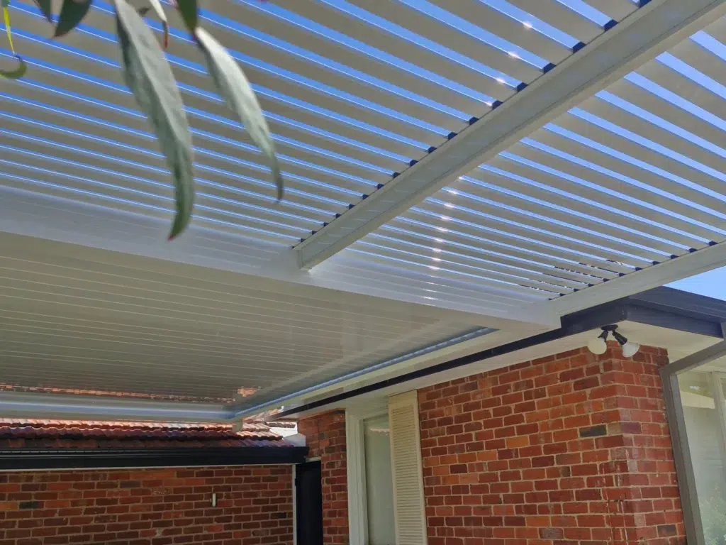 Louvred patio and pergola combination over paved outdoor area with lawn and neighbouring homes, Carnegie Victoria