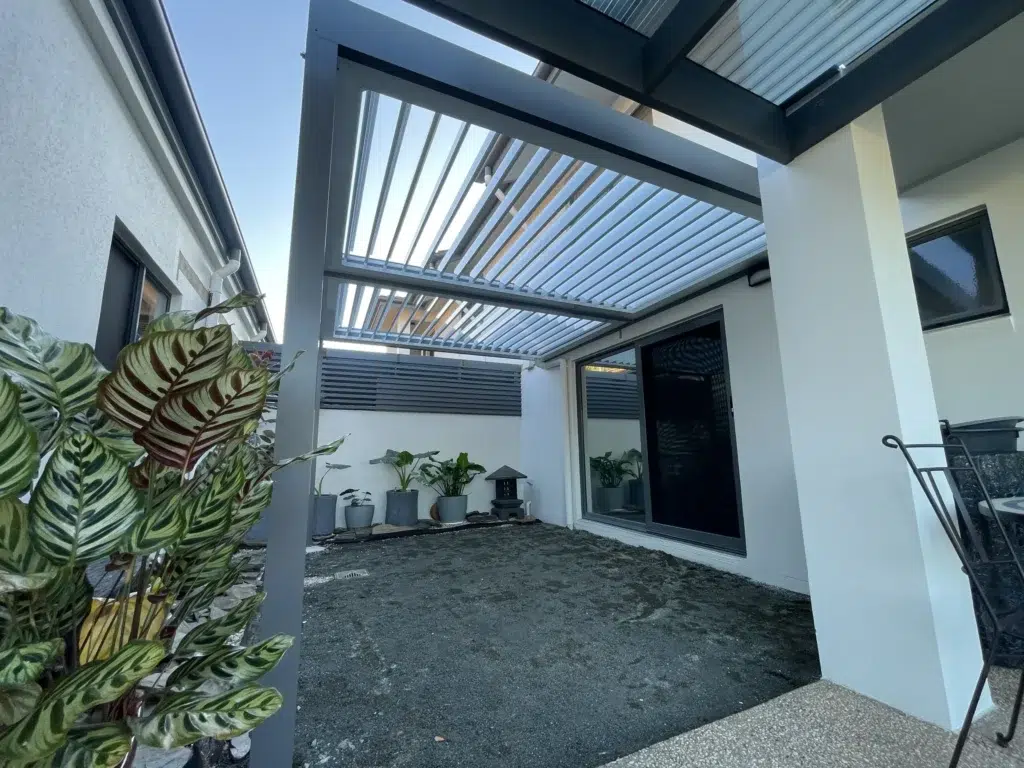 Exterior view of louvred patio with partially open louvres on modern home, Pelican Waters Queensland