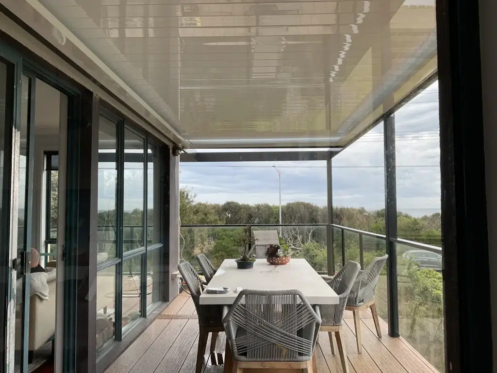 Close-up of grey-framed louvred pergola with open louvres on elevated balcony, Frankston Victoria