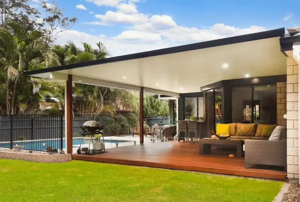 How Much Does a Custom Patio Cost? A Complete Pricing Guide 1 Modern patio with pool and greenery